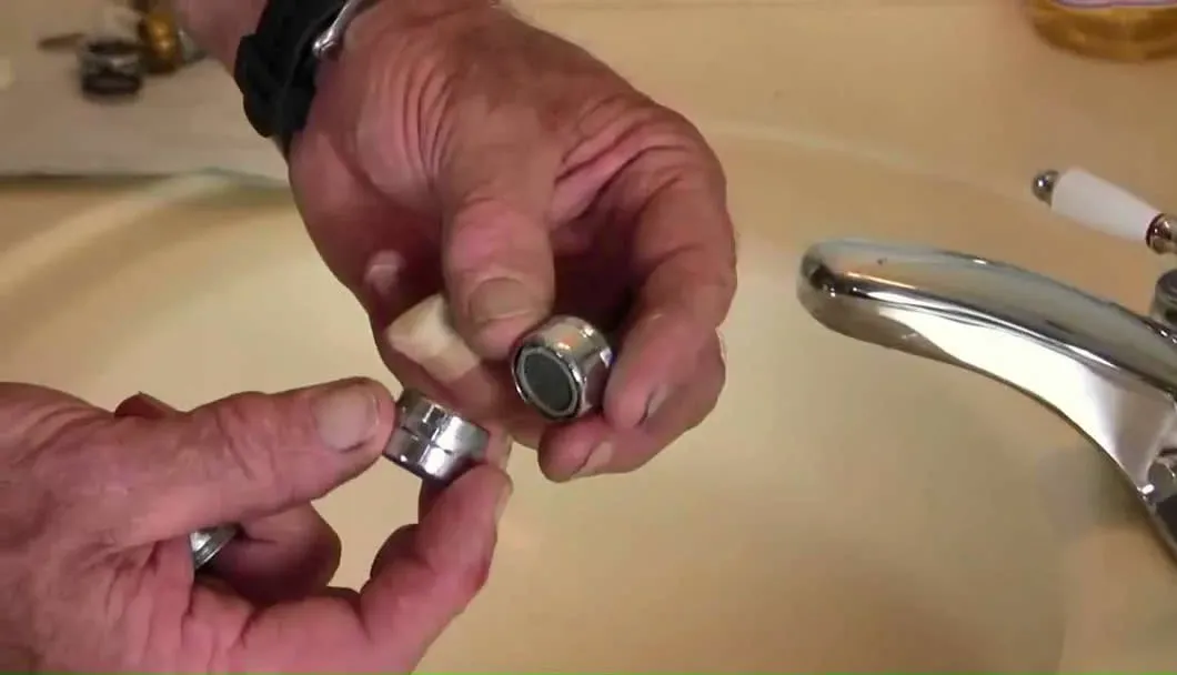 Plumber repairing a bathroom faucet