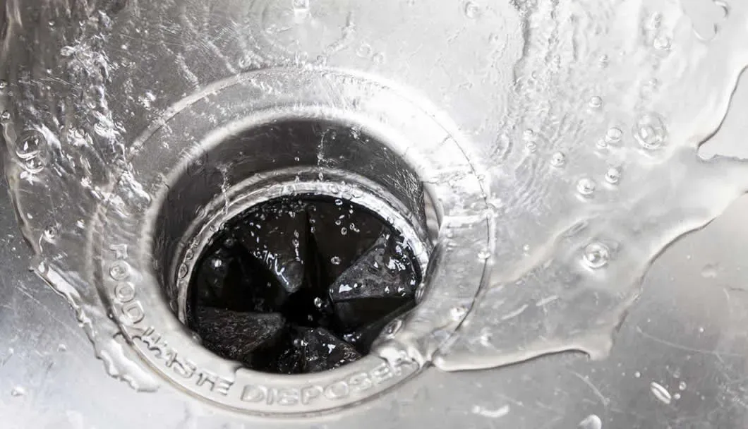 Water draining into a kitchen garbage disposal